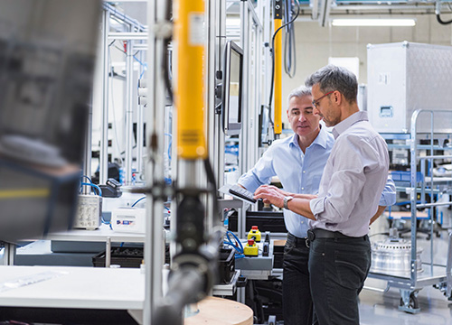 Two men working in factory