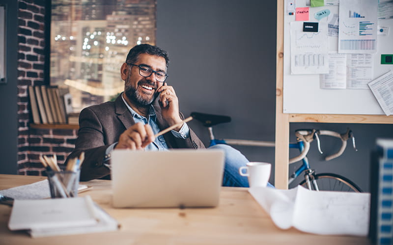 Man speaking on phone in office