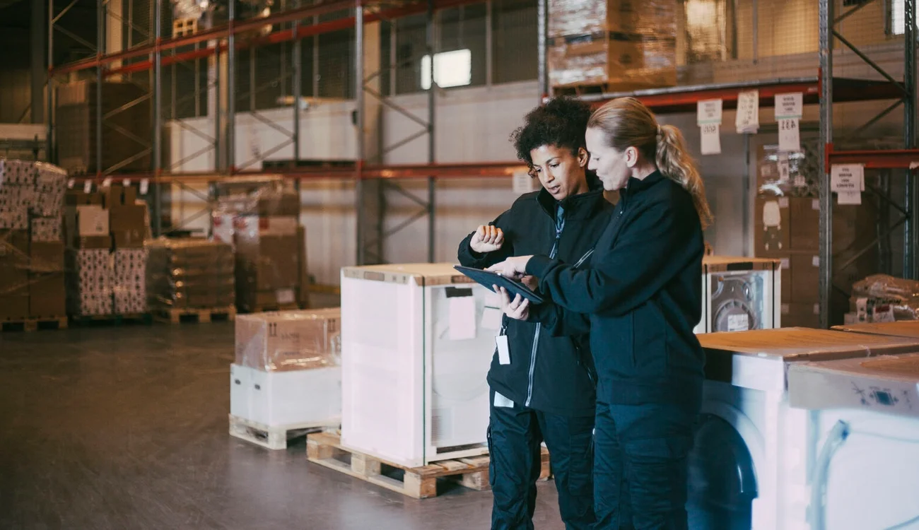 Two women working in warehouse